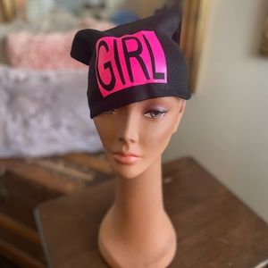 Signature black stocking cap for women. With the wording GIRL in hot pink